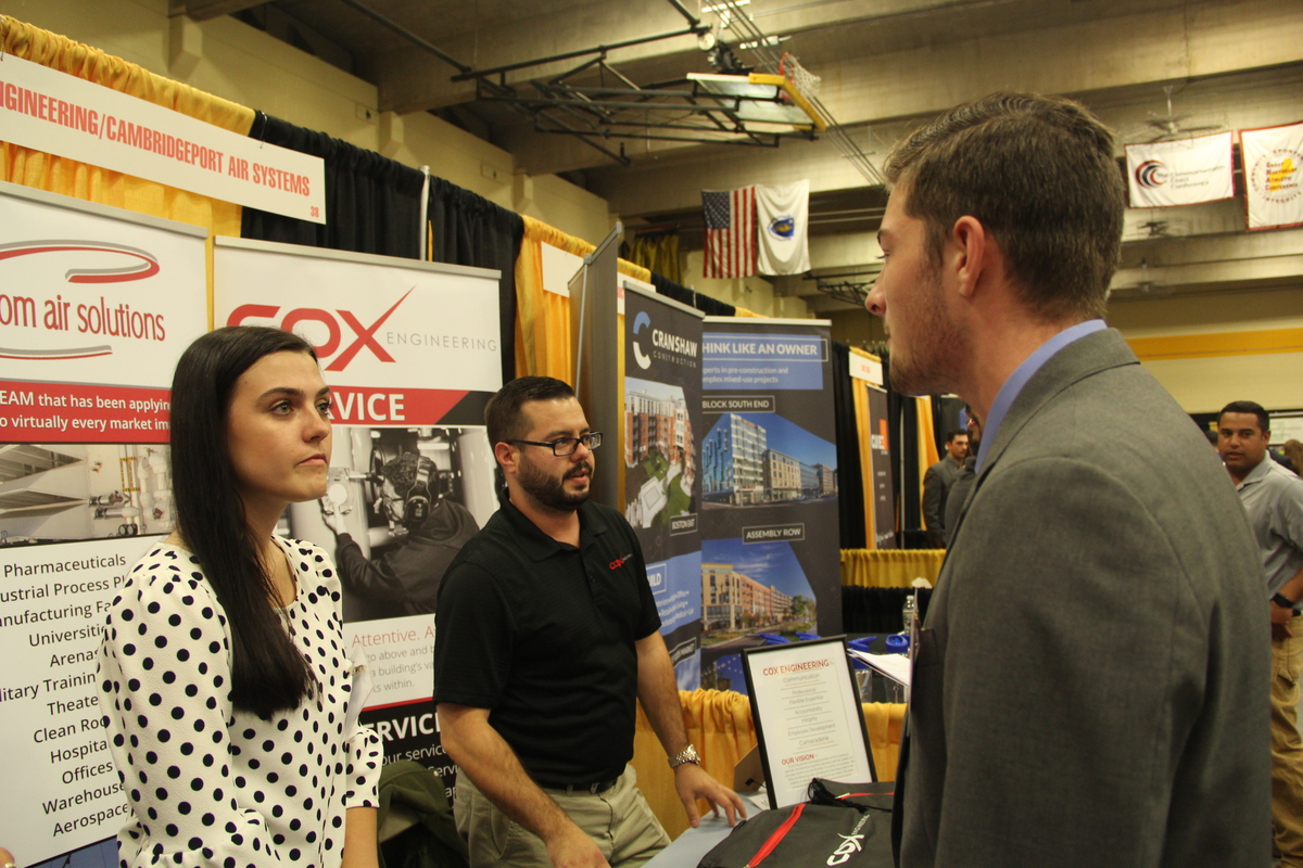student talking to co-op employer at career fair