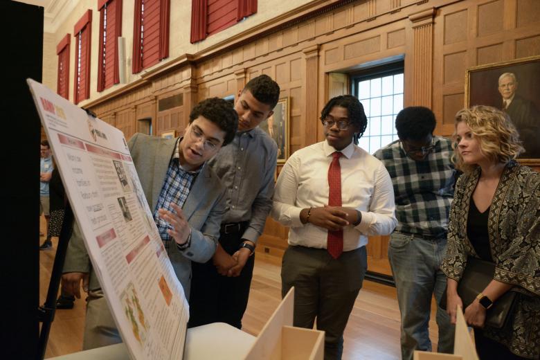 Students next to a poster presentation
