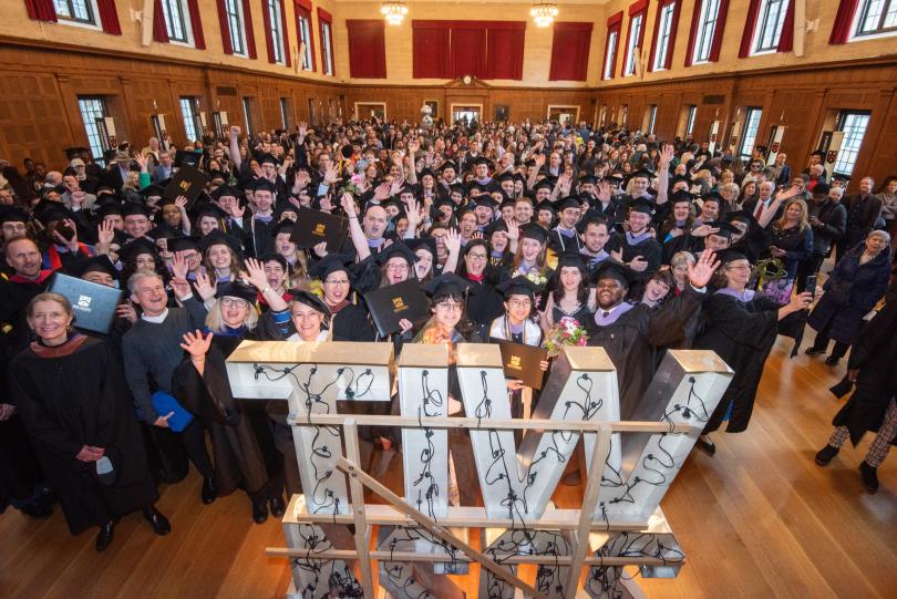 large group of people wearing graduation gowns