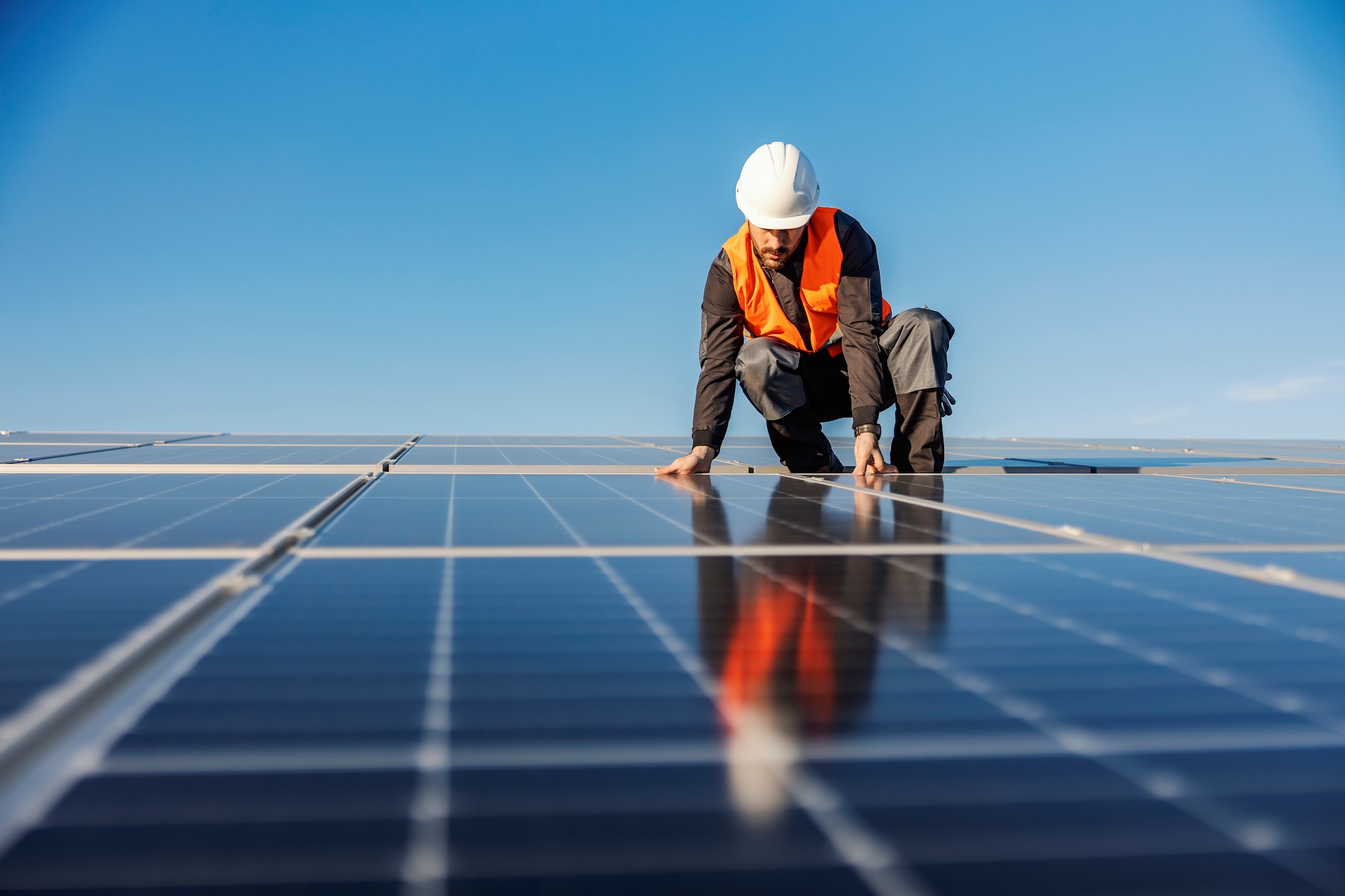 person working on solar panels