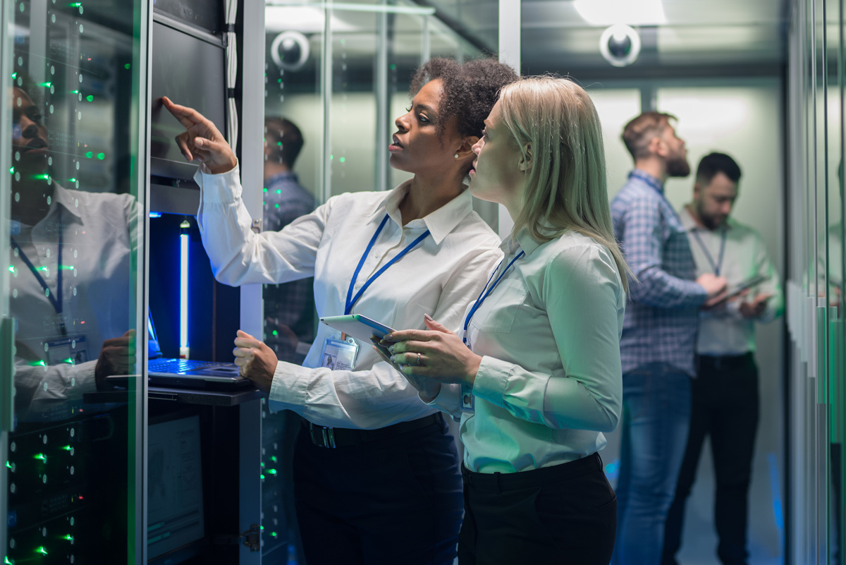 Two women working in a server room