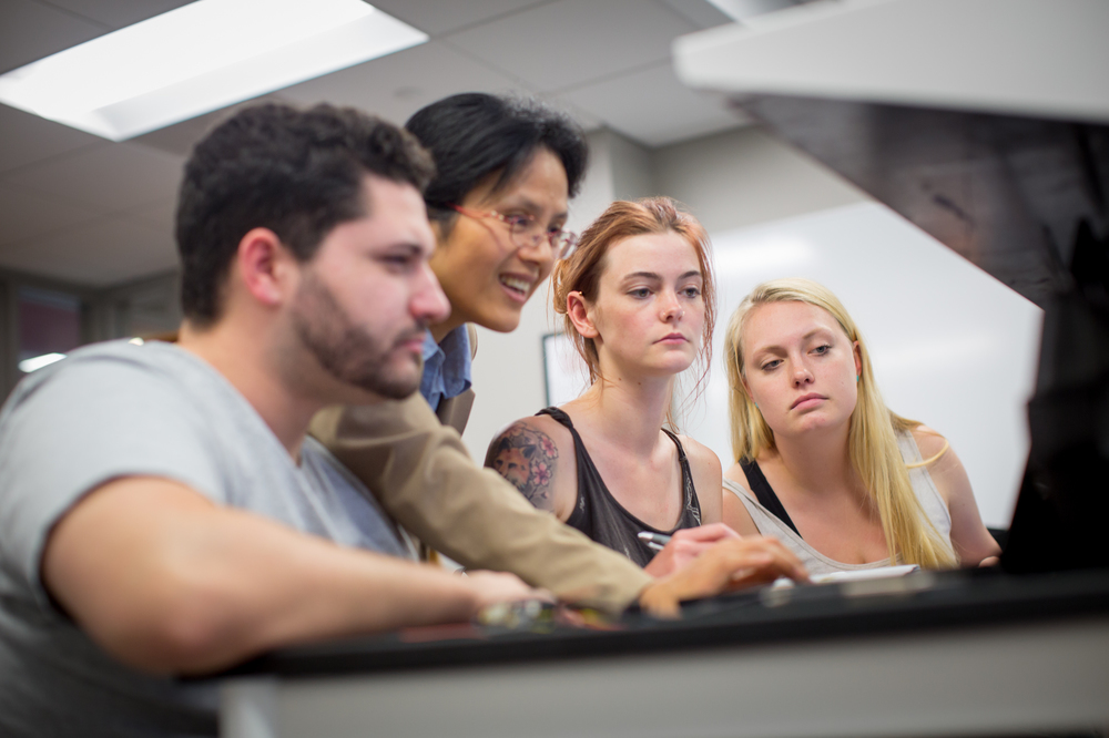 students looking at laptop