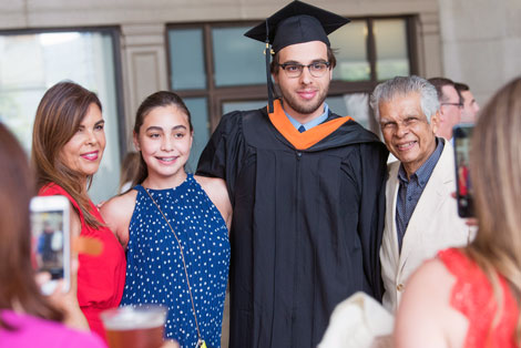 A family poses around their son on Commencement day