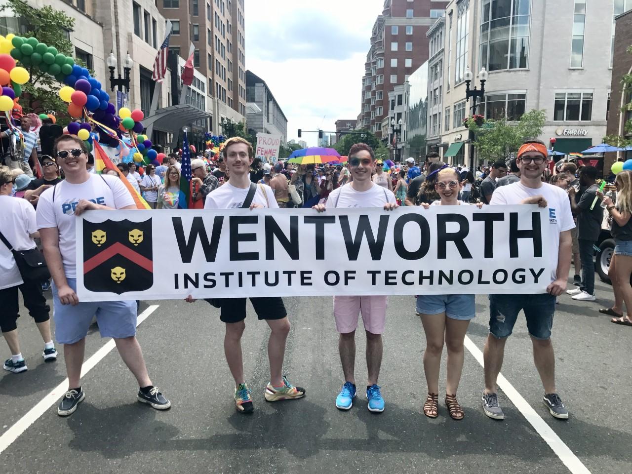 Students at Boston Pride holding a sign that says Wentworth