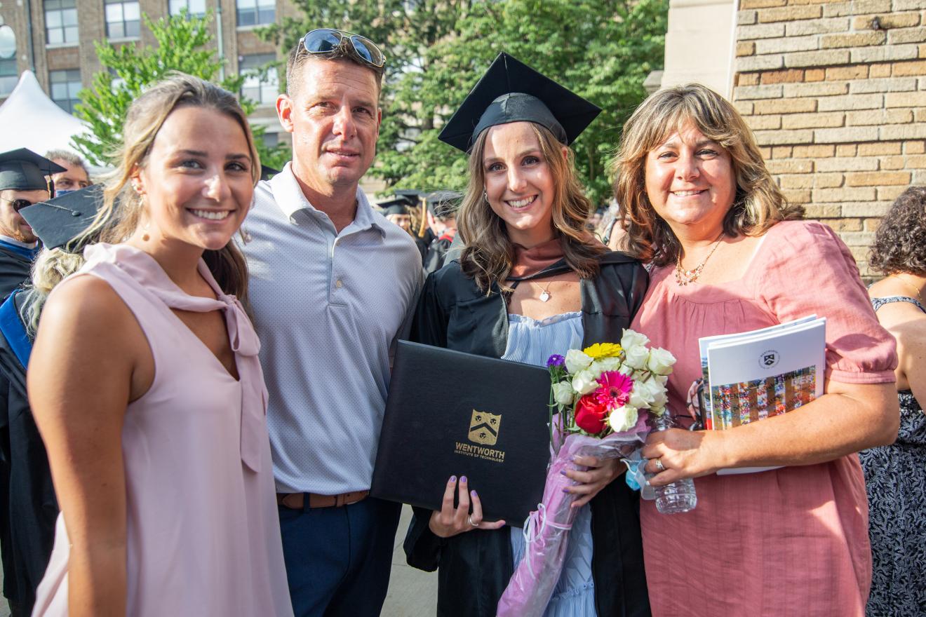 family of four celebrating a graduation