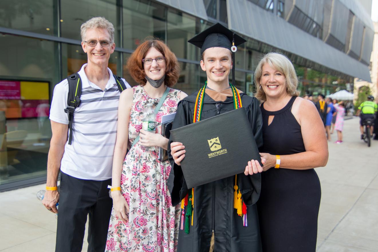 family of four celebrating a graduation