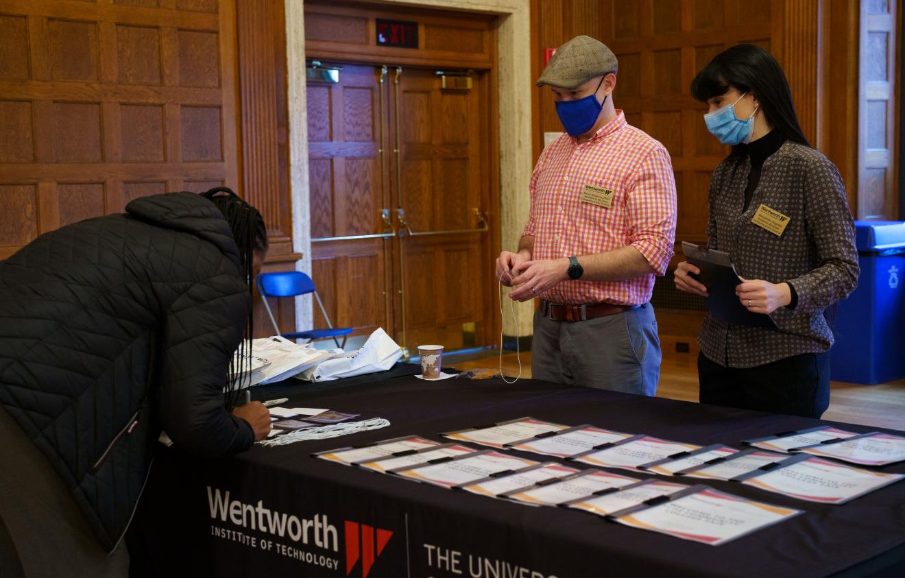 woman signing into an event at a table