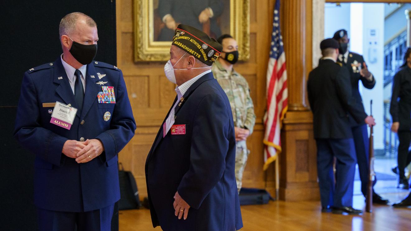 men in uniform speaking to one another