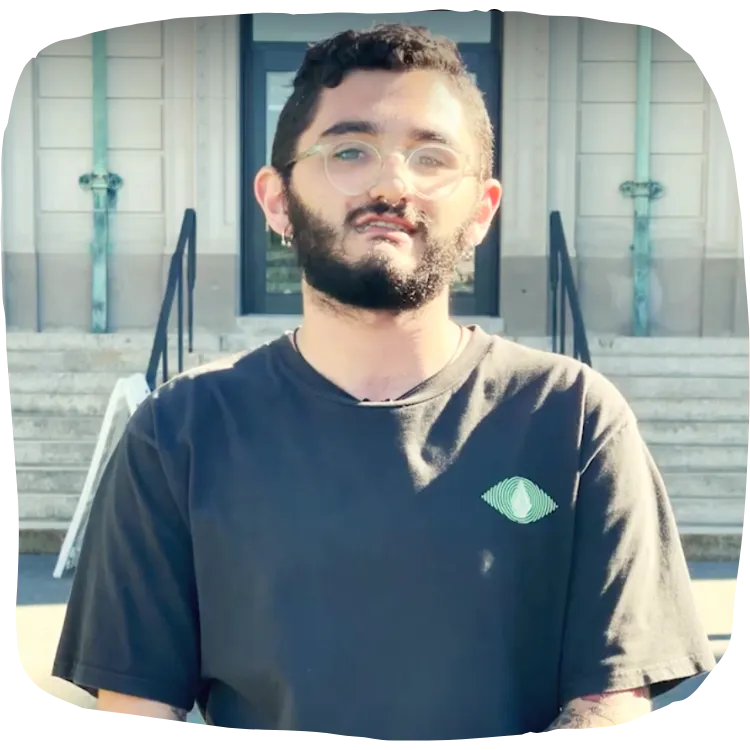 student standing in front of school building