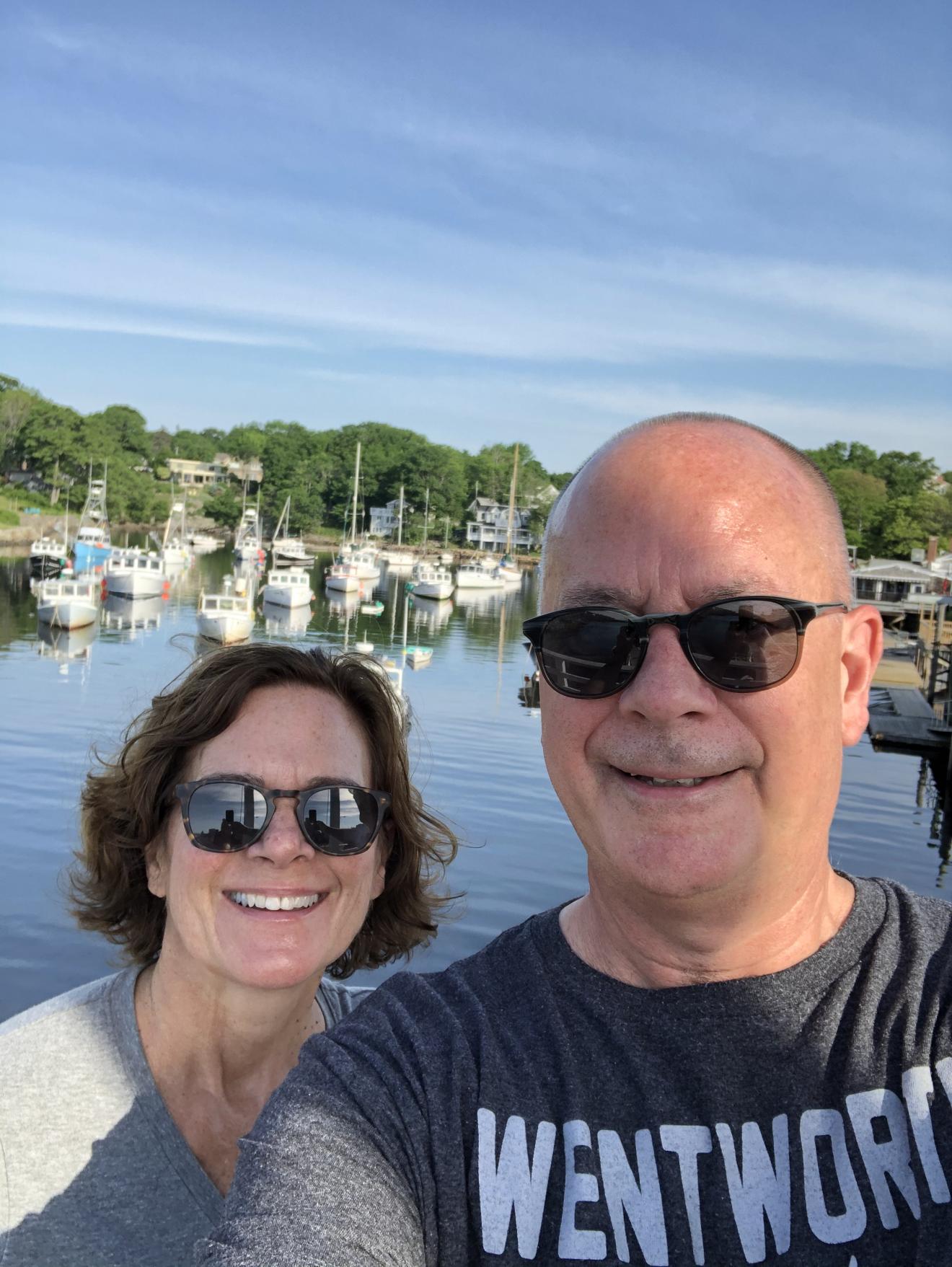 two people posing near a harbor