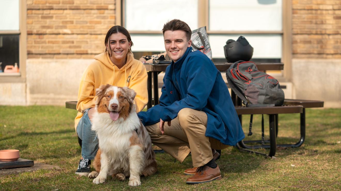 people posing with dog