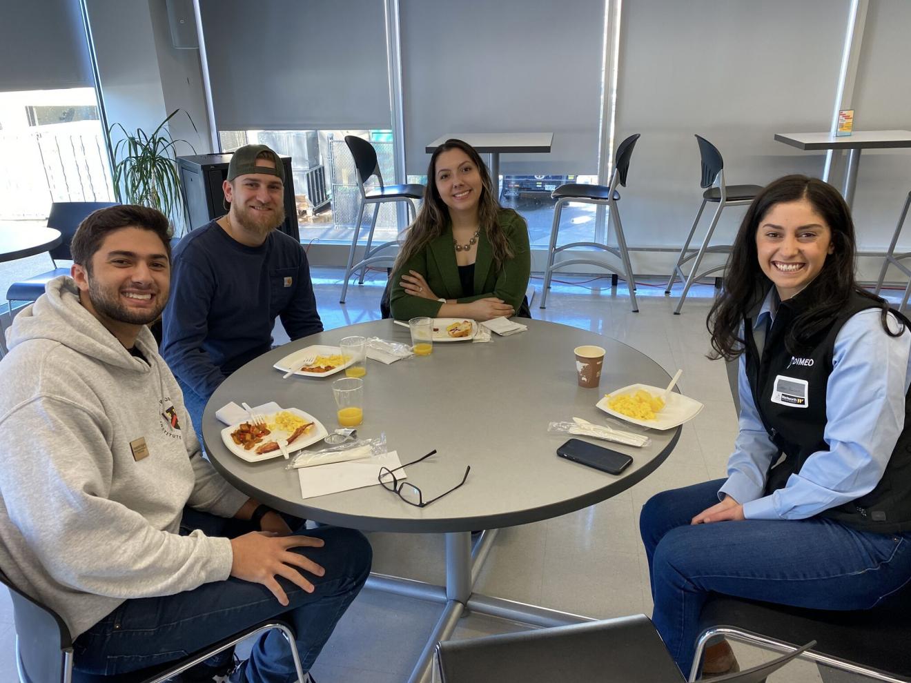 four people sitting at a table