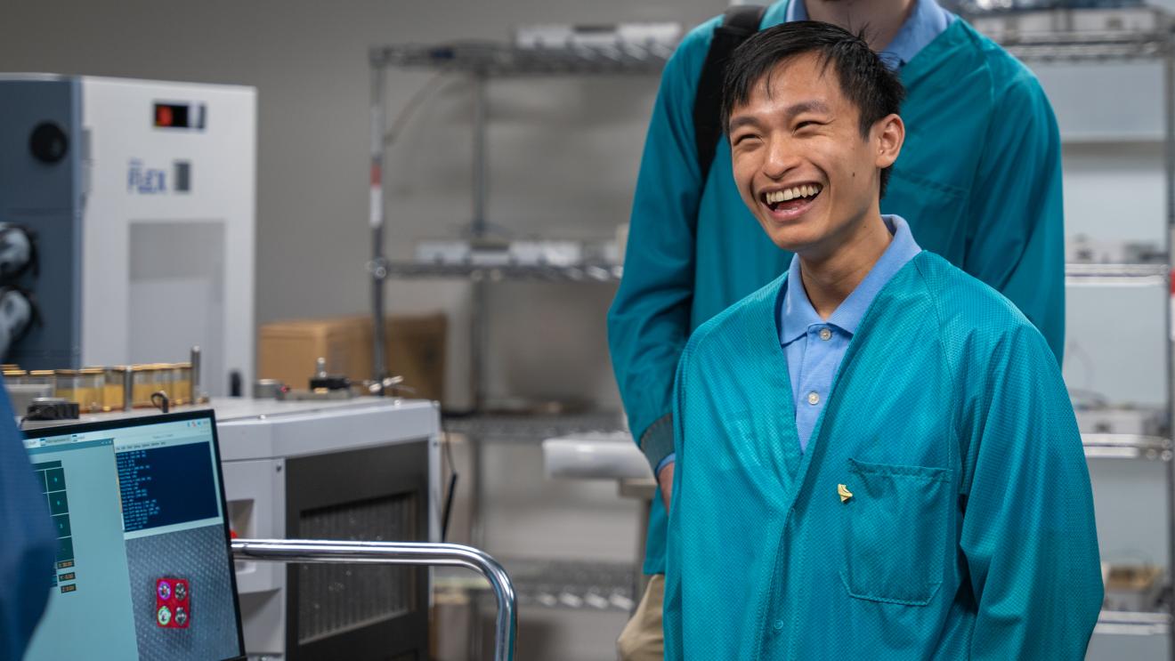 person in lab coat smiling