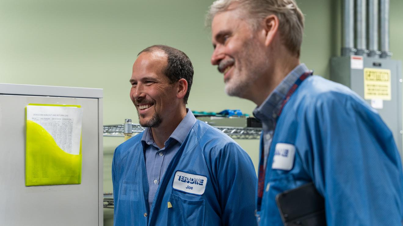 two men in lab coats smiling