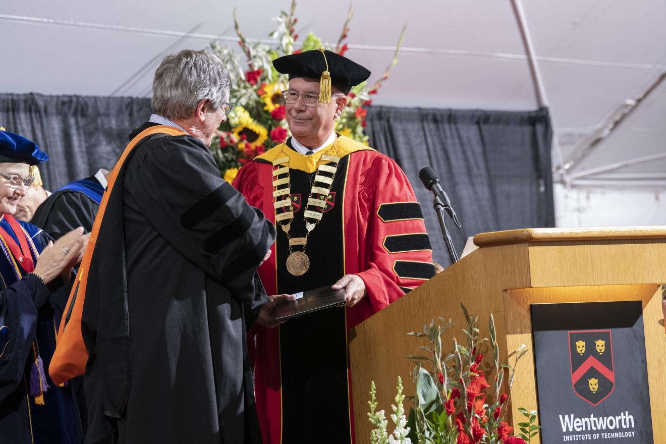 two men shaking hands on stage