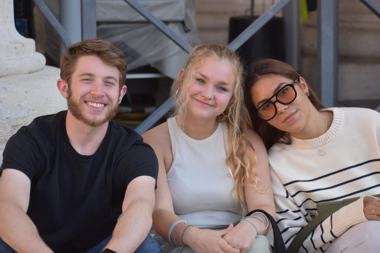 three students looking at the camera smiling