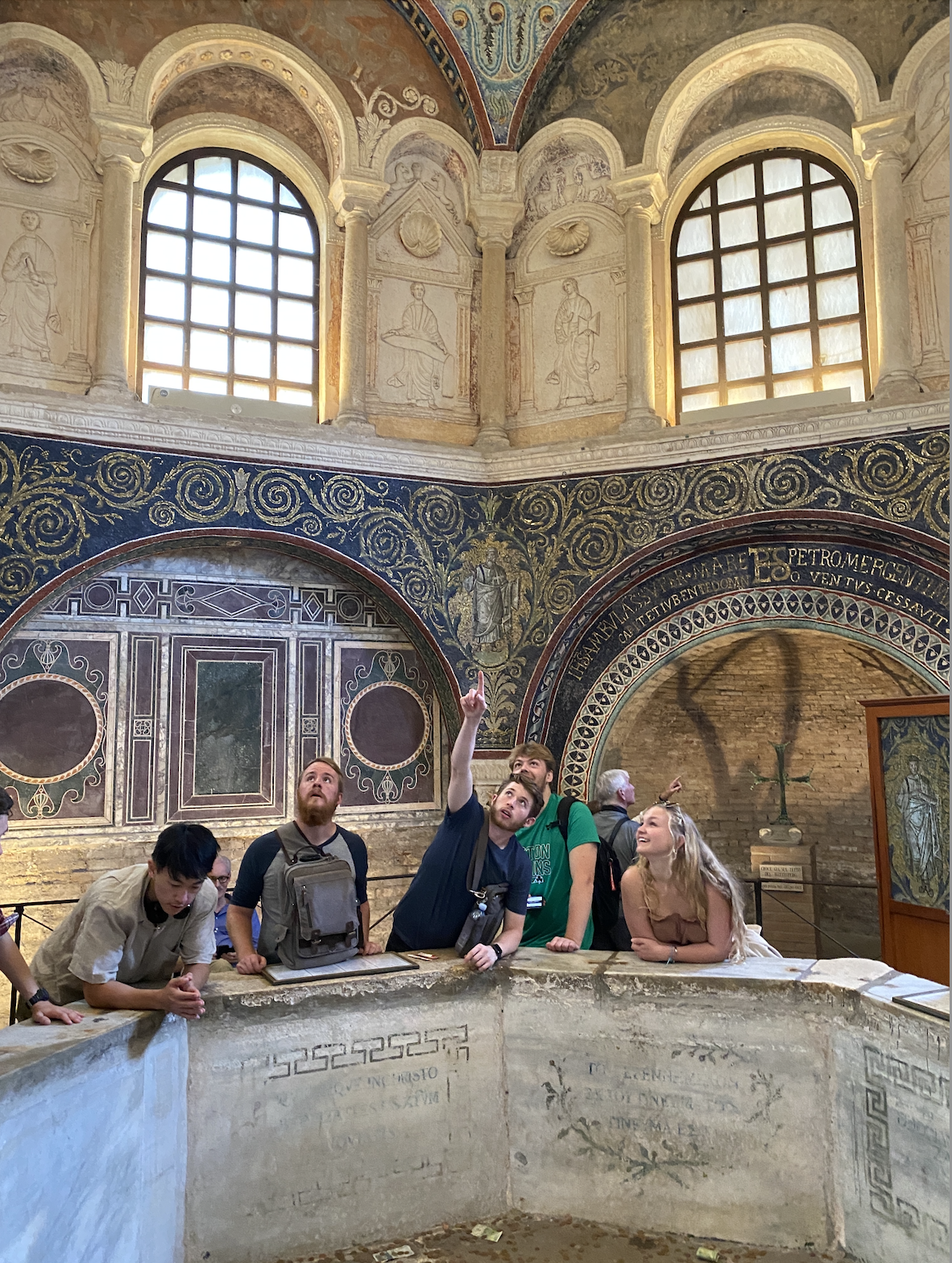 group of students in a historic building examining architectural features