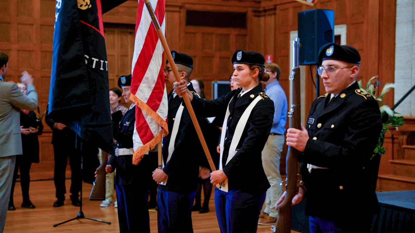military cadets holding the american flag