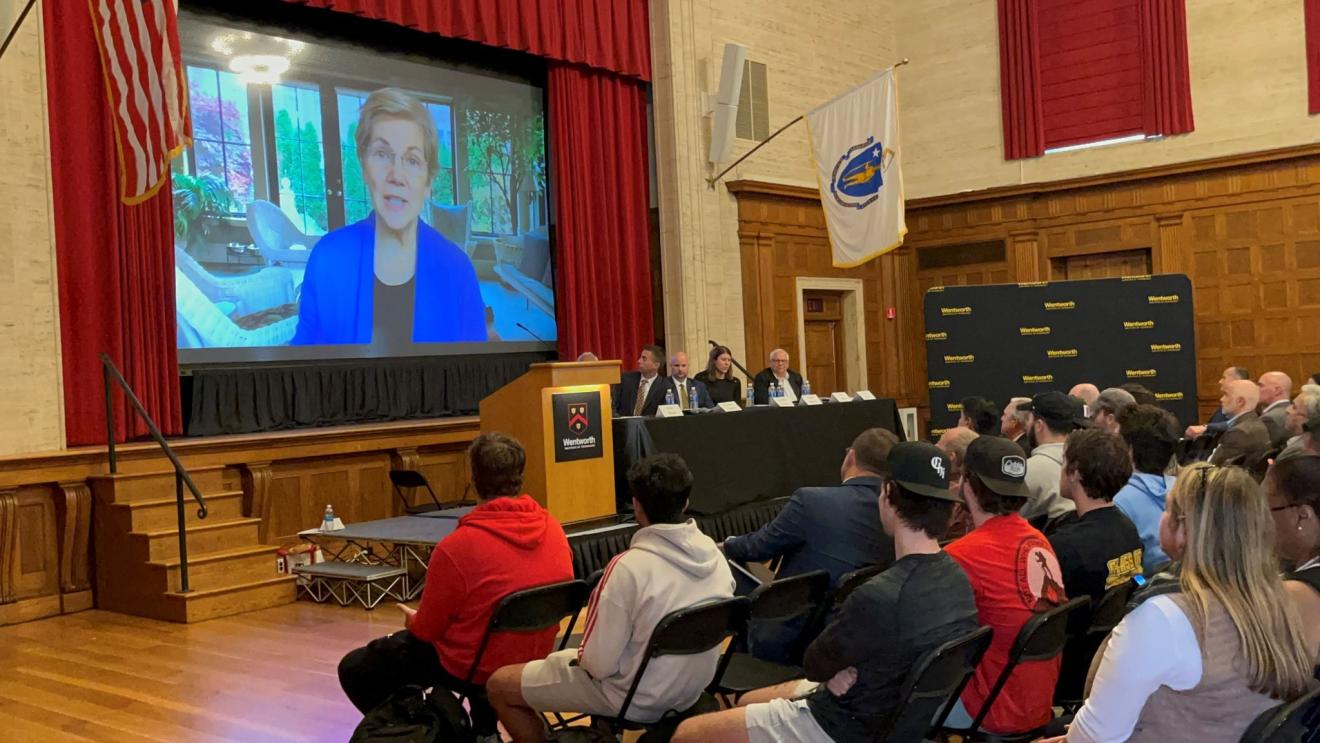 a woman appears on a big screen