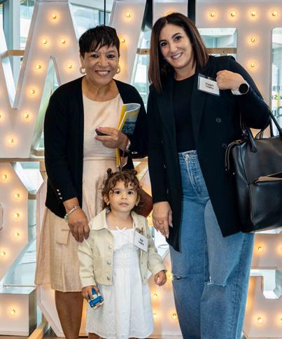 two women and one young girl smiling at camera