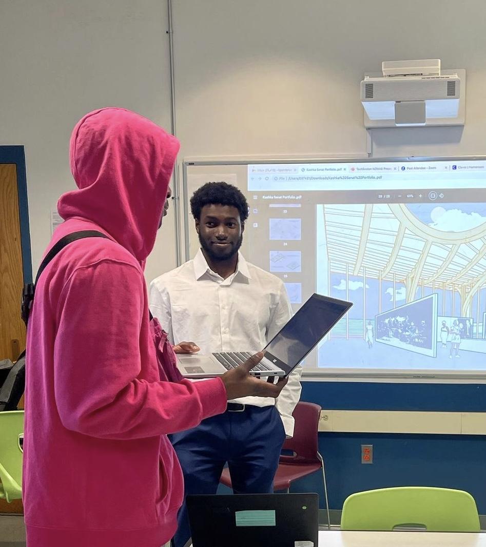 man working with a student in a classroom