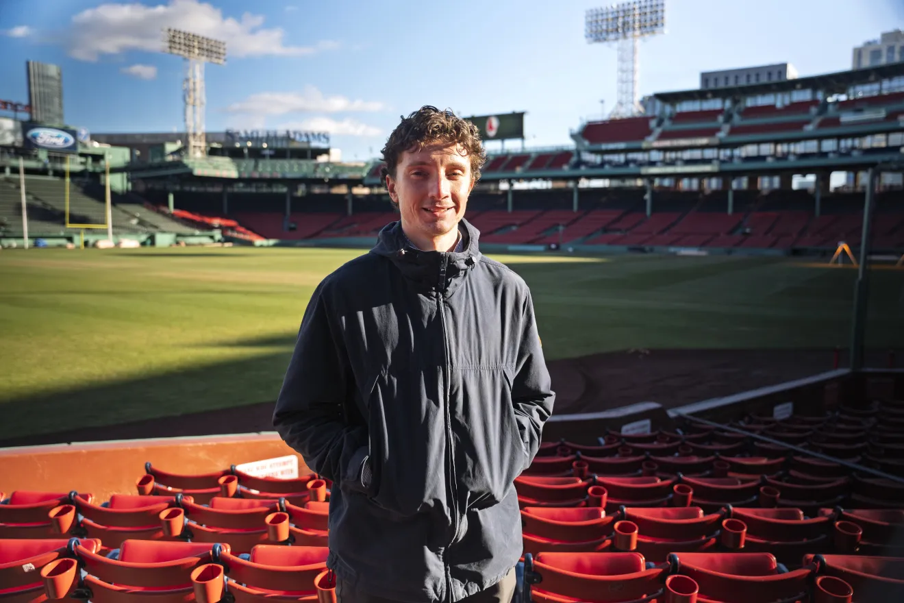 a man standing in front of a baseball park