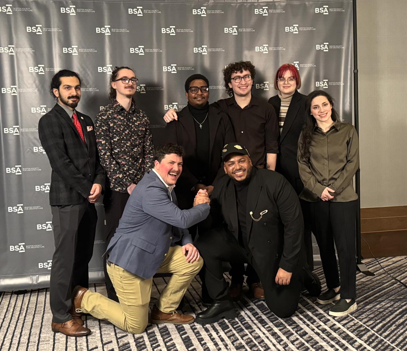 a group of people dressed up at an awards gala