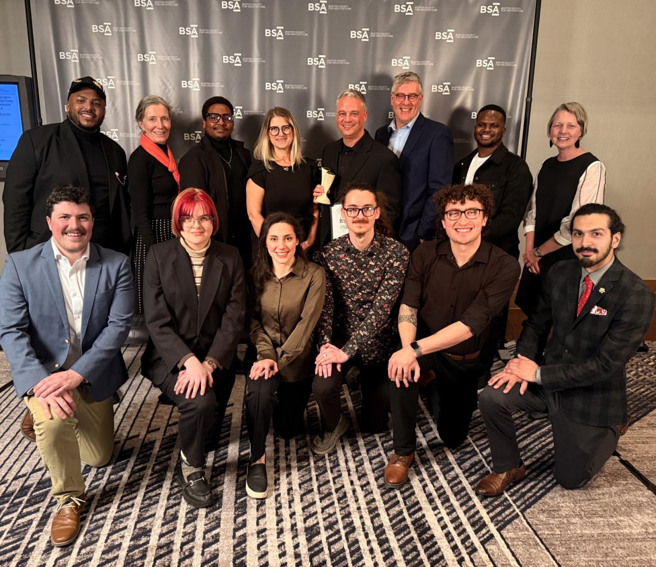 a group of people dressed up at an awards gala