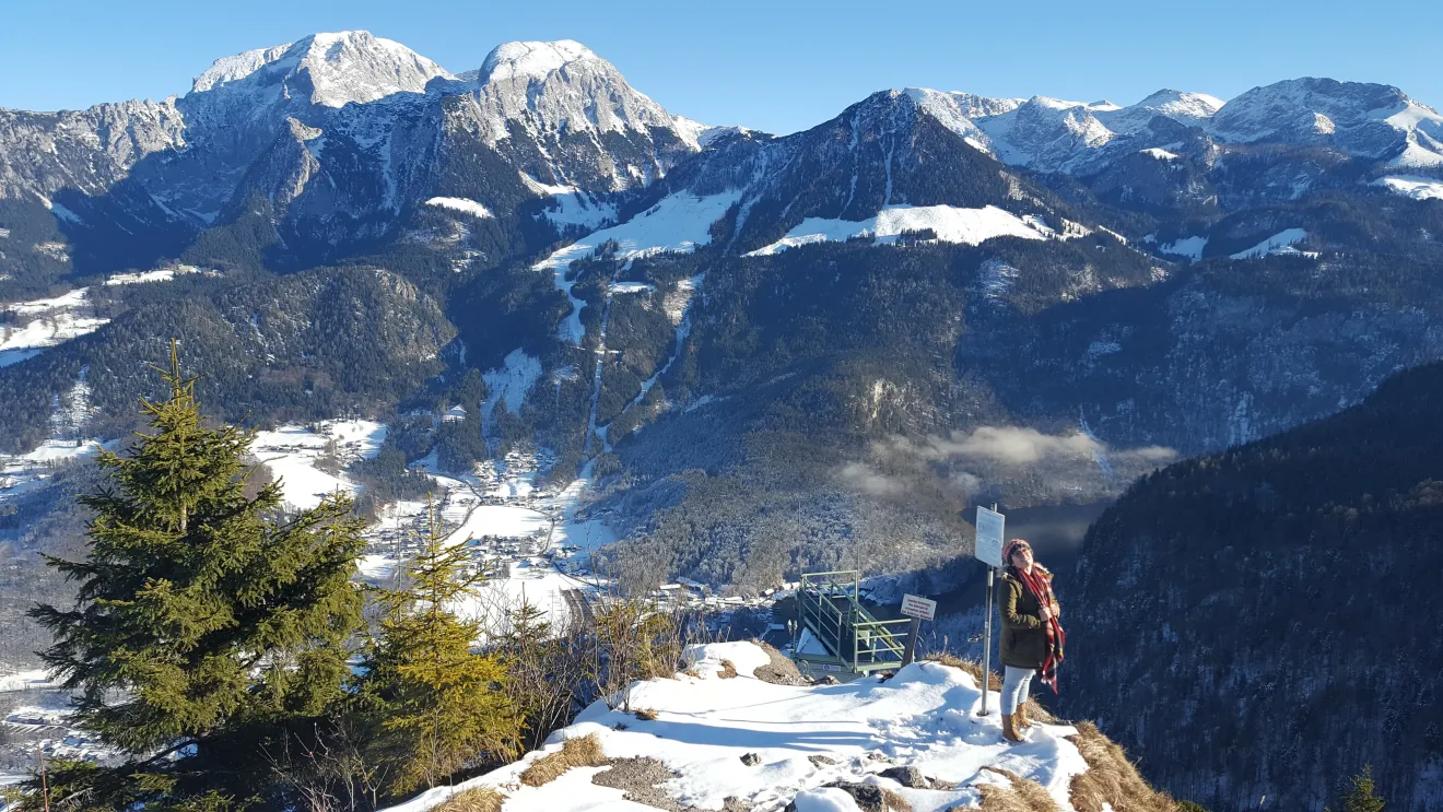 a woman stands on a mountaintop