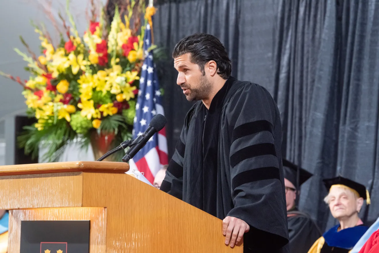 a man speaks at a podium