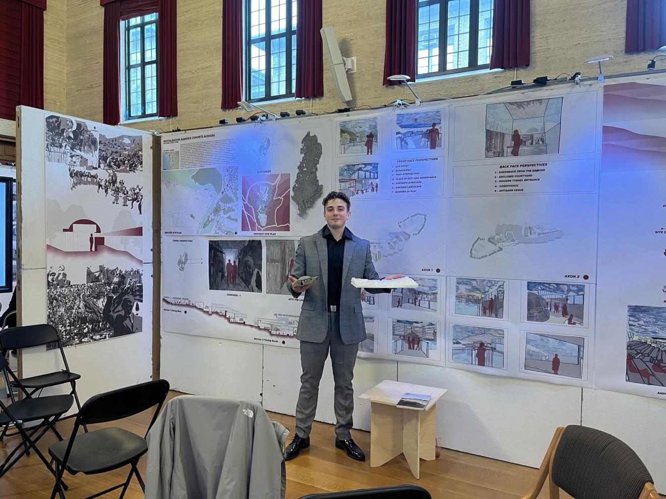 man presenting an architectural thesis in an auditorium