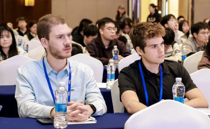 Students watch a presentation at a conference