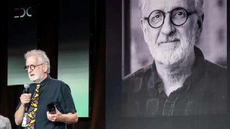 a man accepts an award on stage at an event