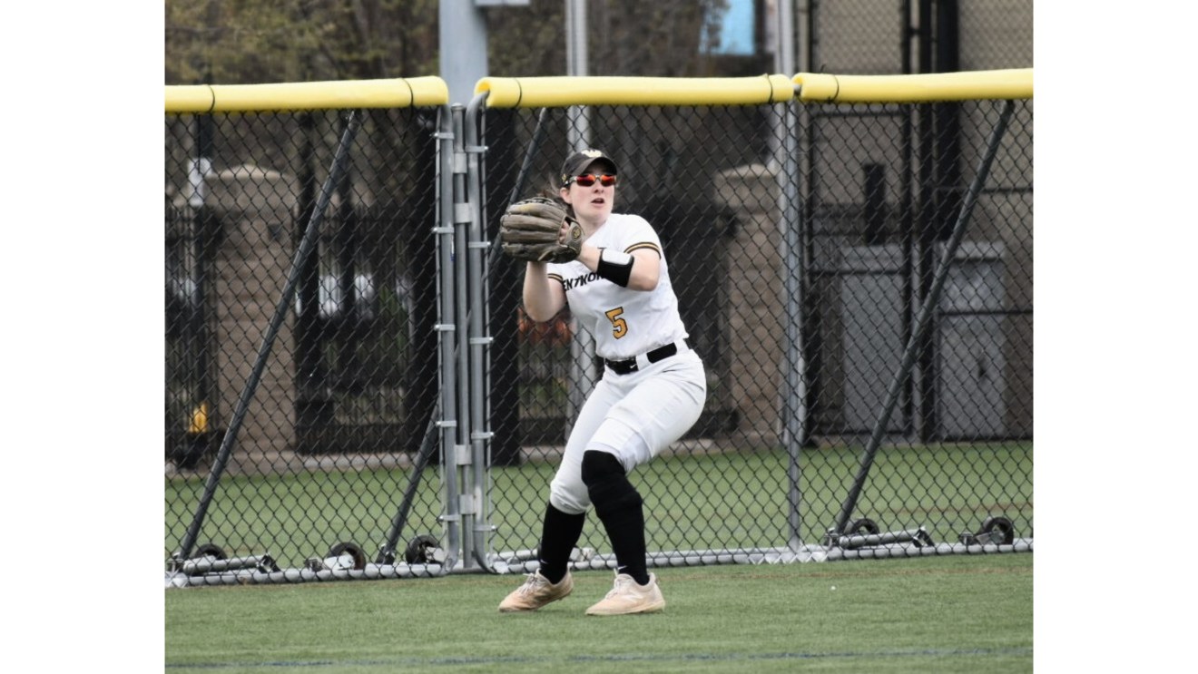 a woman throwing a softball from the outfield