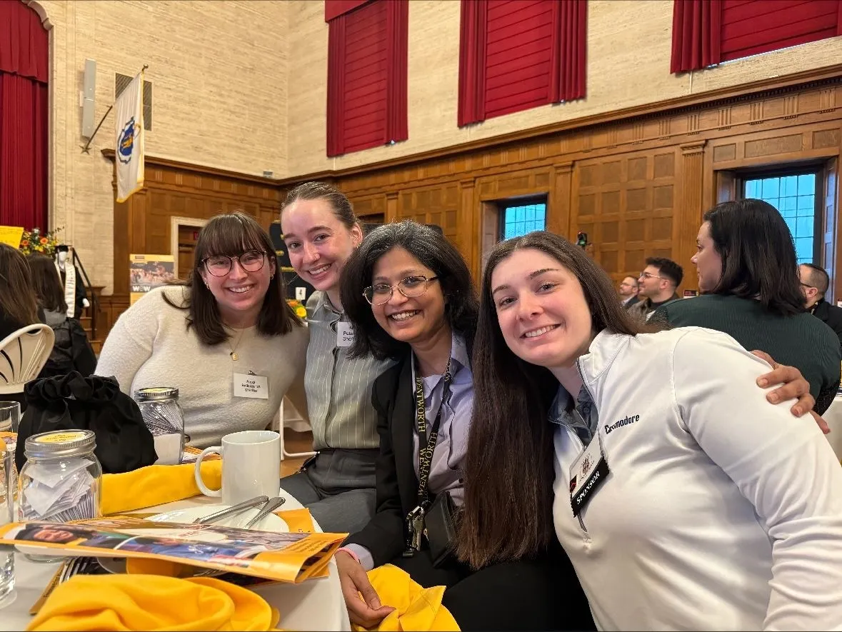 a group of woman attending a campus event smile for the camera