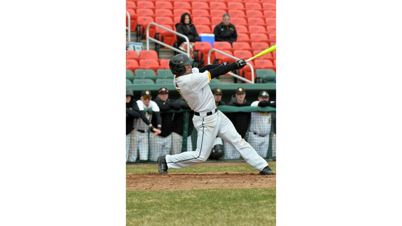 a man in a baseball uniform swinging a bat