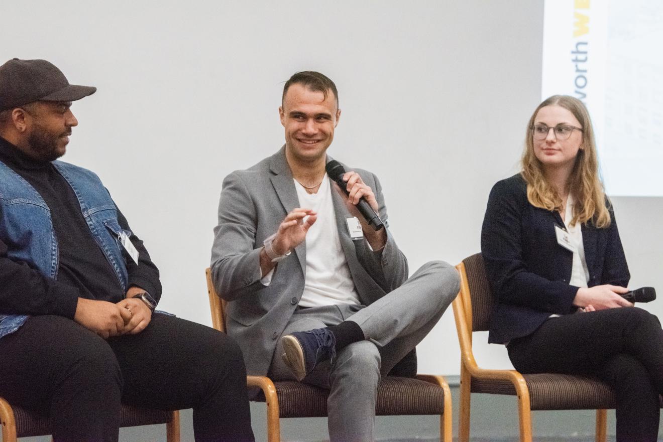 three people speaking as part of a panel discussion