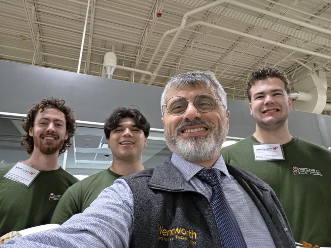 a teacher and three students take a selfie together
