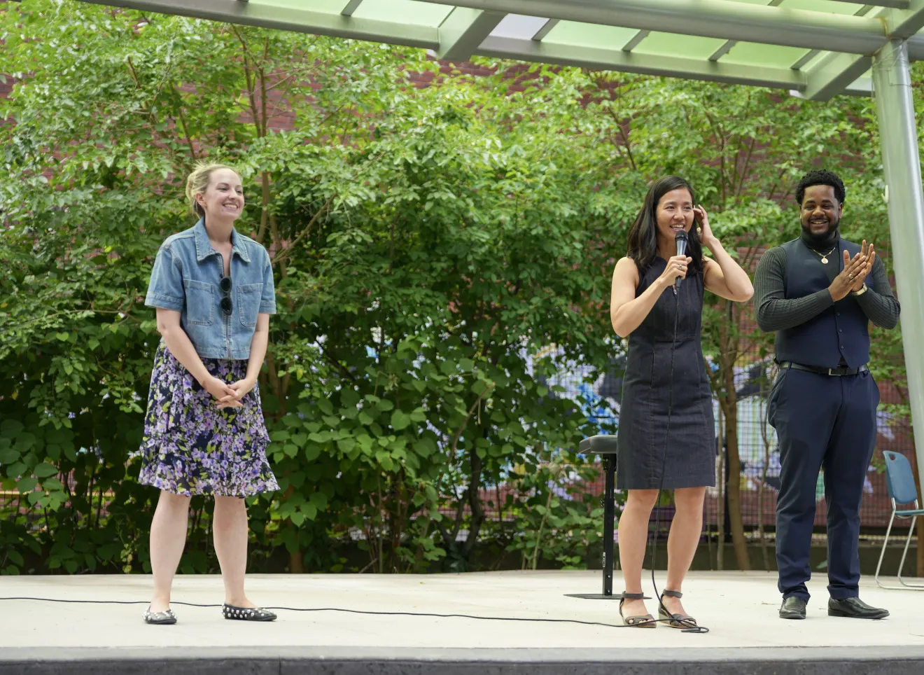 three people on a stage