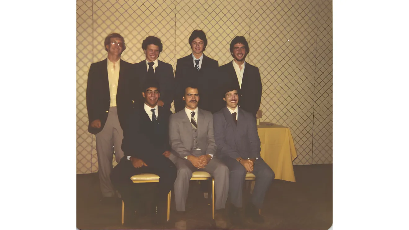 a group of men in suits at a dinner