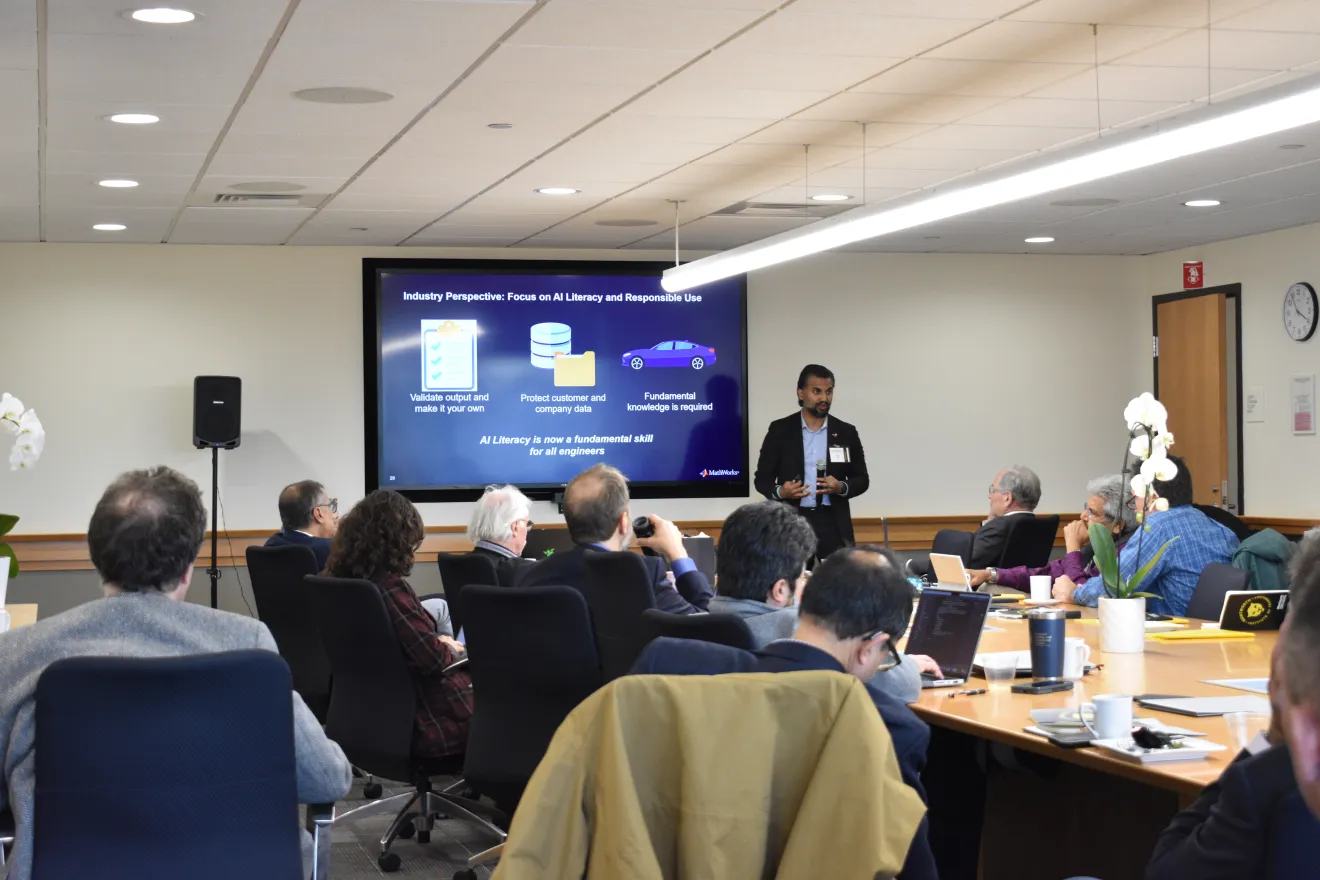 a person speaks to a group in a conference room