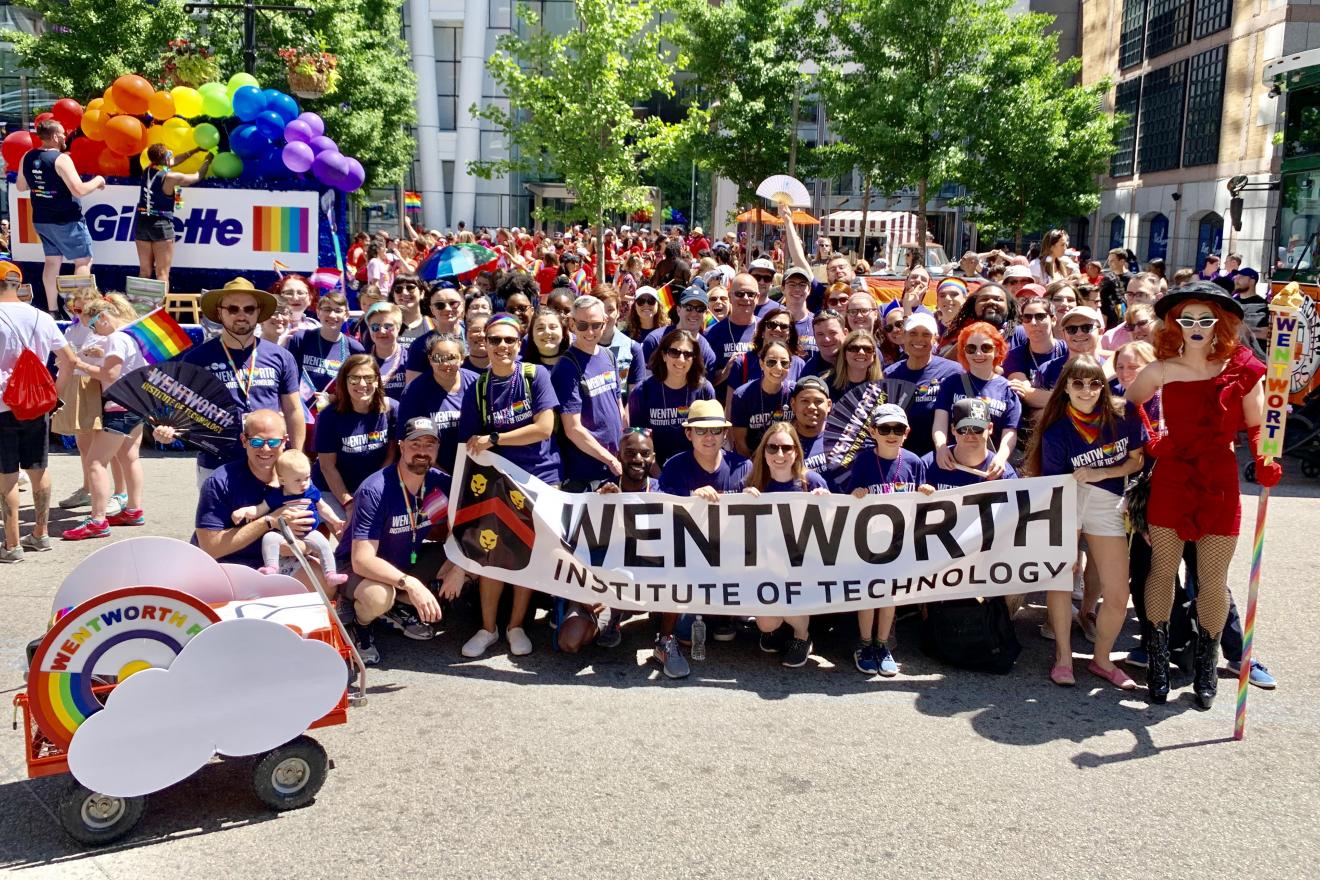 large group of people holding up a wentworth banner