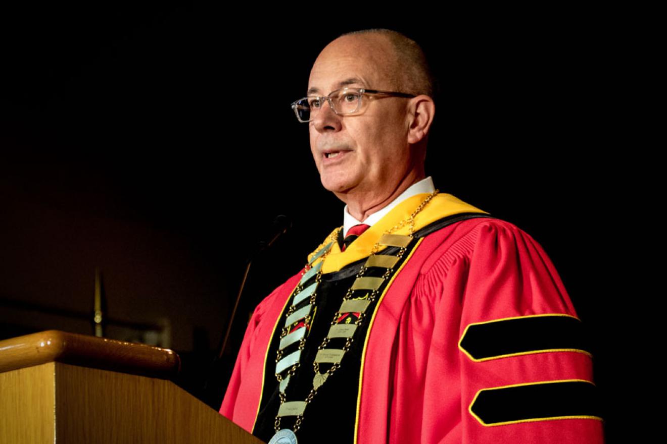 President Thompson speaks at a podium during the inauguration ceremony. 