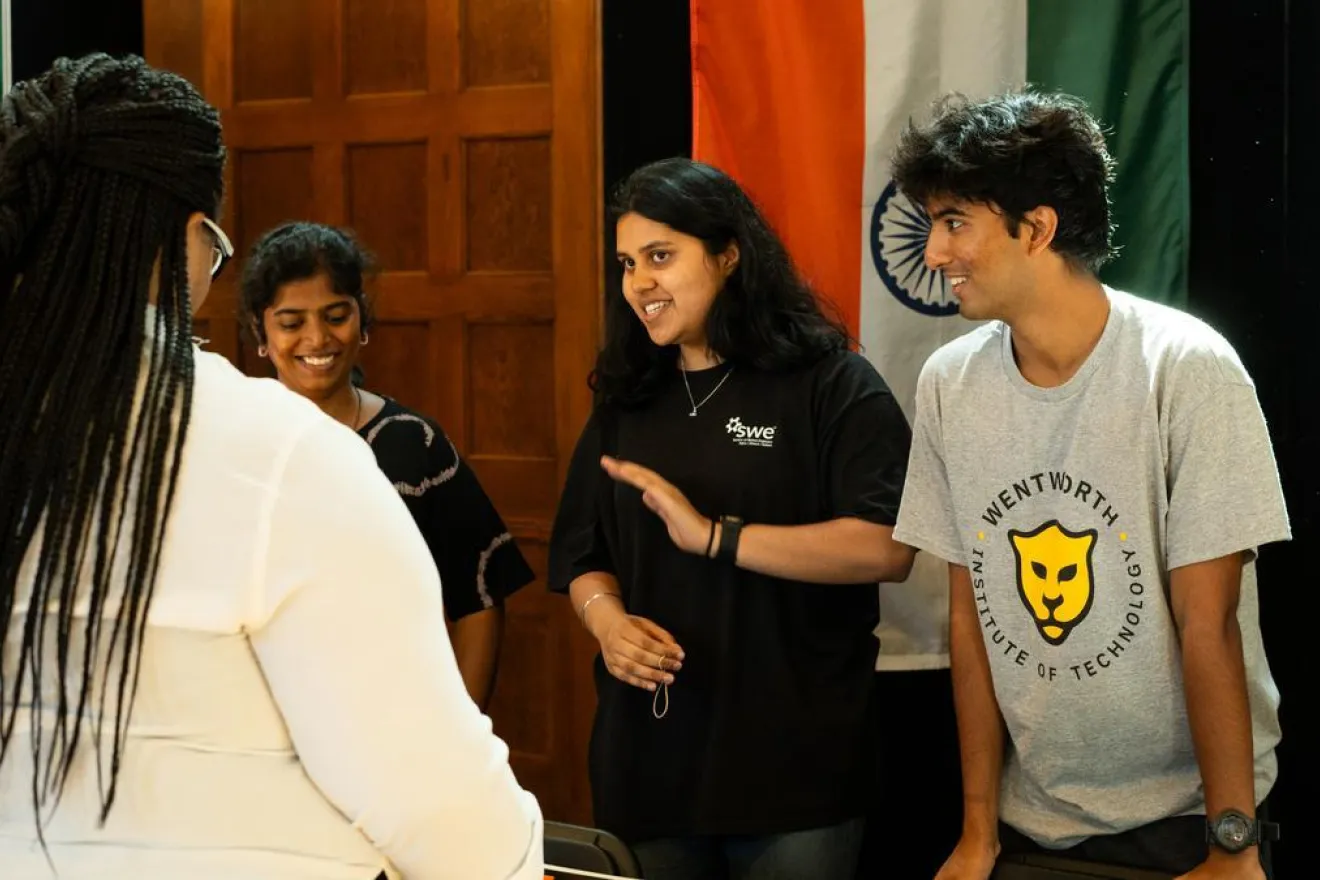 Students of different backgrounds smile at the Around the World food festival