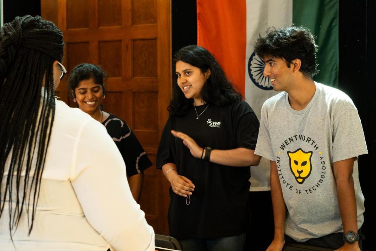 Students of different backgrounds smile at the Around the World food festival