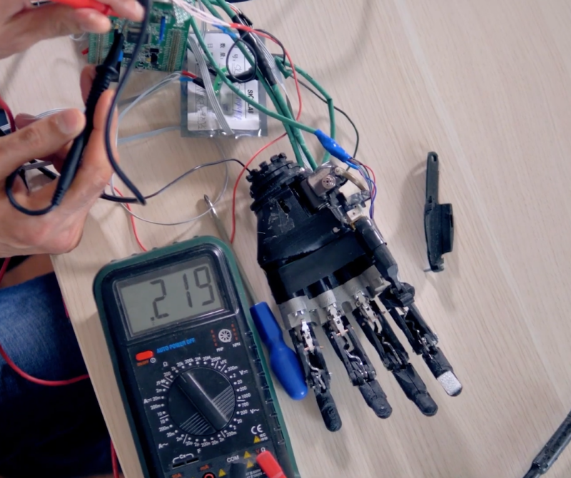 A student works on a circuit board using alligator clips