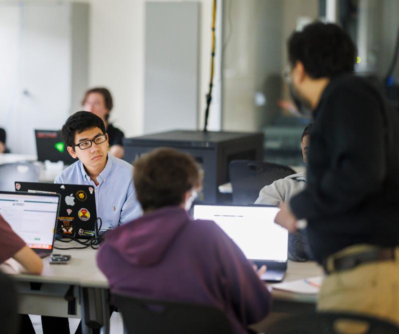 A student works with his laptop in class in one of the classrooms used for cybersecurity education