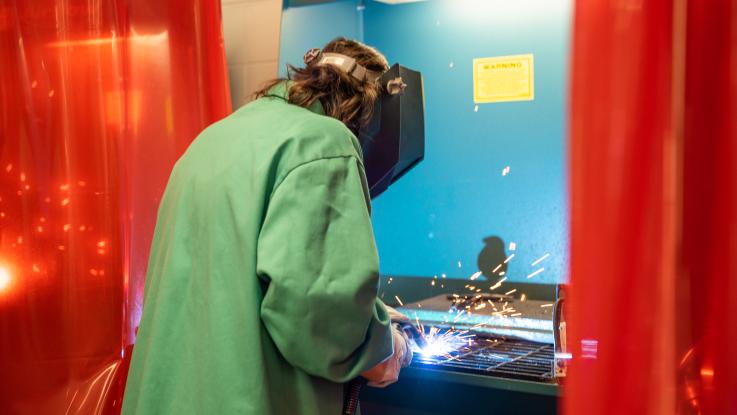 Student using the foundry equipment 