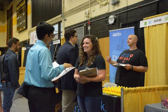 students speak with employers at a career fair