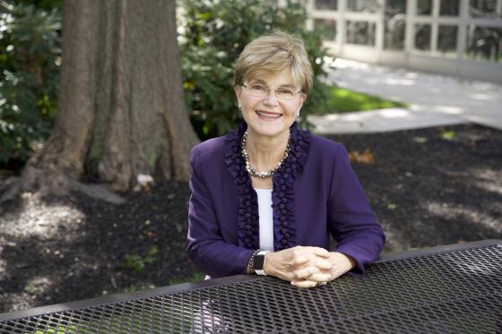 a woman sitting at a bench